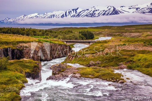 Bild på The creek flows among the flat tundra